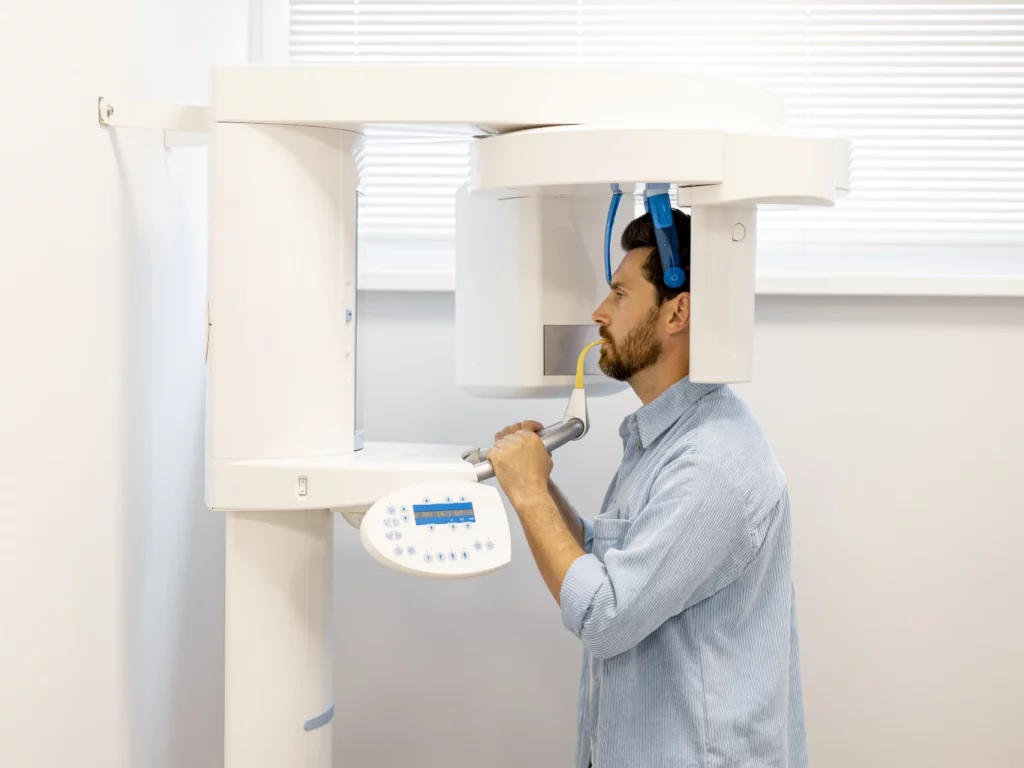 man doing CBCT 3D x-ray at dental office